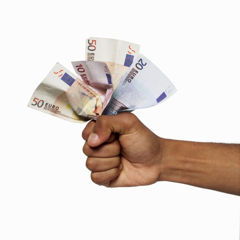 close up view of a hand holding bank notes